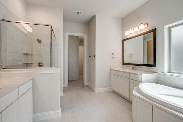 full bath with two vanities, visible vents, a sink, a shower stall, and baseboards