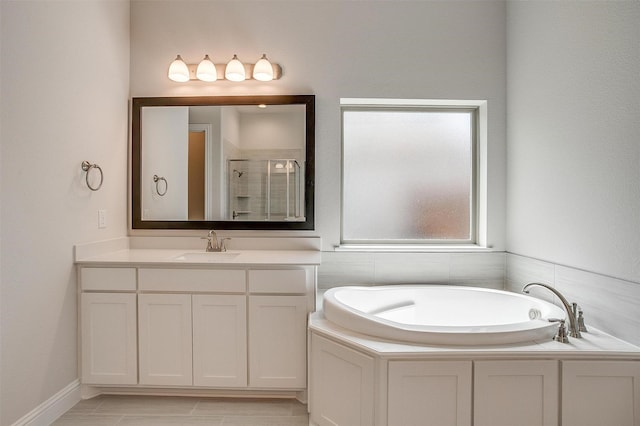 full bathroom with a bath, a shower stall, and vanity