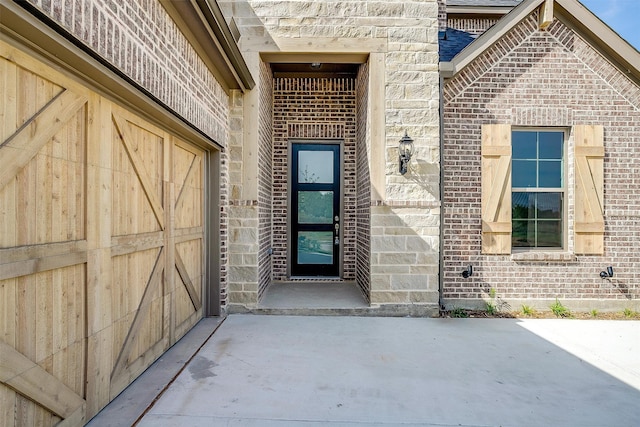 view of exterior entry with a garage