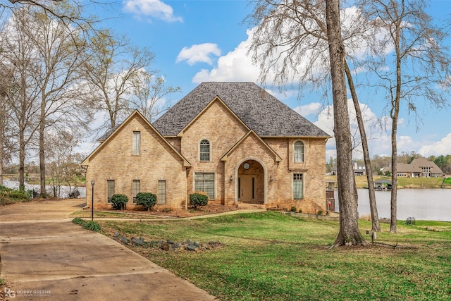 view of front of home featuring a front yard and a water view