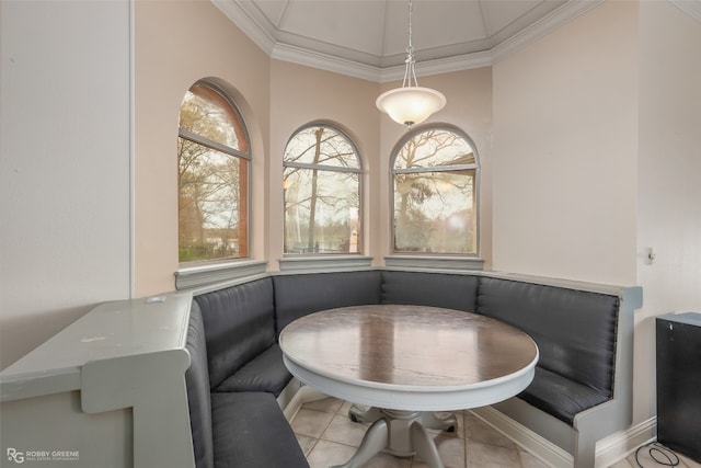 dining area featuring crown molding and light tile floors