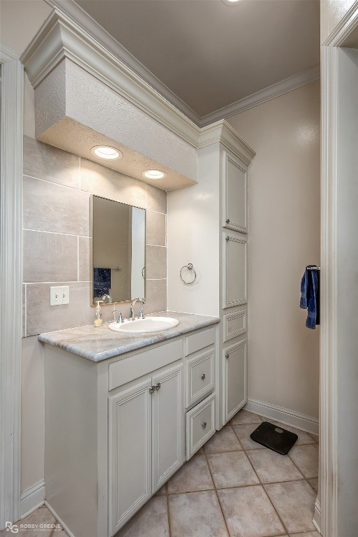 bathroom featuring tile walls, ornamental molding, tile floors, and oversized vanity