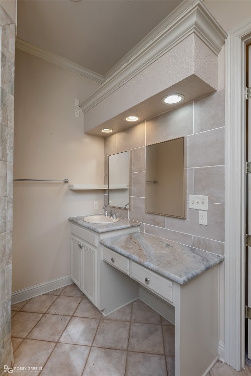 bathroom featuring vanity, tile floors, crown molding, and tile walls