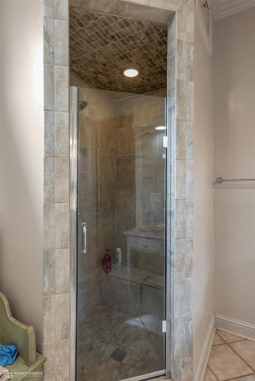 bathroom featuring ornamental molding and a shower with door