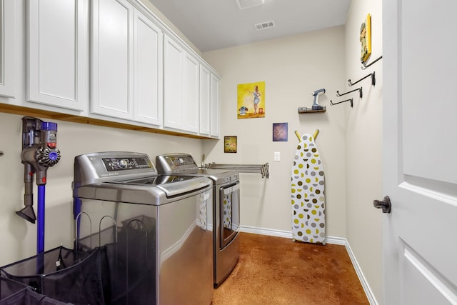 laundry area featuring carpet flooring, cabinets, and separate washer and dryer