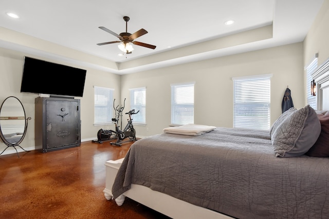 bedroom featuring a raised ceiling and ceiling fan