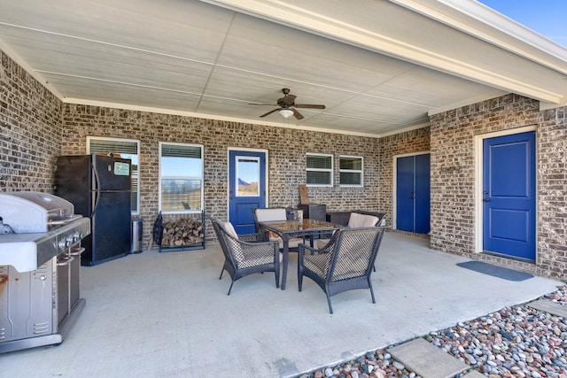 view of patio with area for grilling and ceiling fan