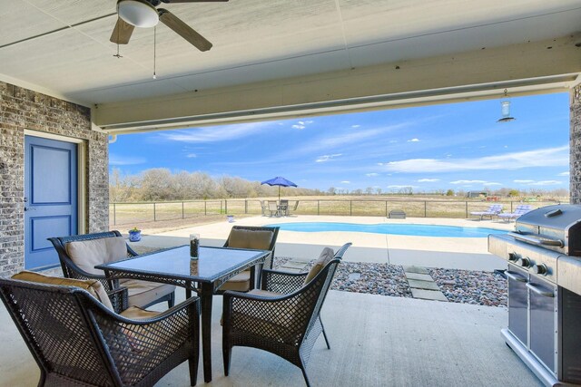 view of patio / terrace with a fenced in pool, grilling area, and ceiling fan