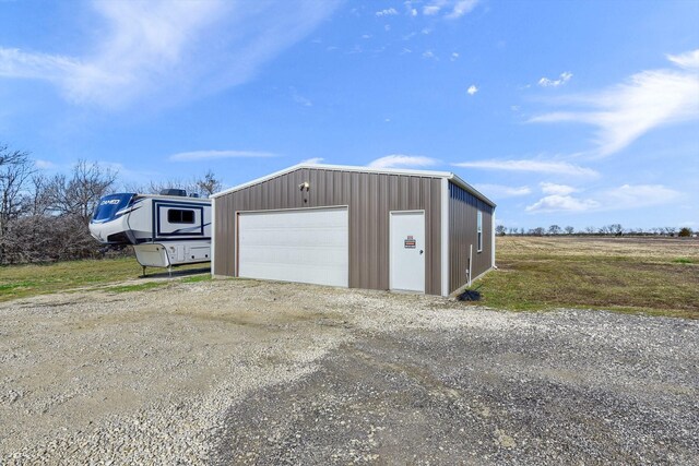 garage featuring a rural view