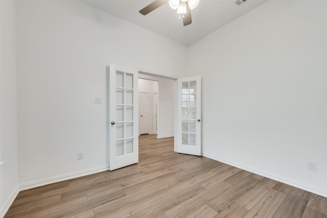 spare room with french doors, light hardwood / wood-style flooring, and ceiling fan