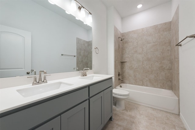 full bathroom with vanity, tiled shower / bath combo, and toilet