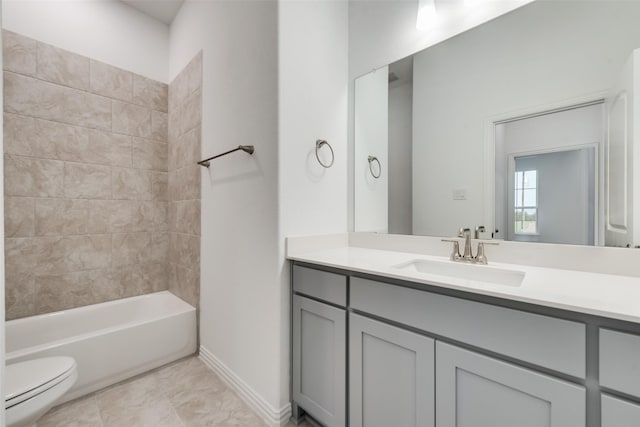 full bathroom with tiled shower / bath, vanity, and toilet