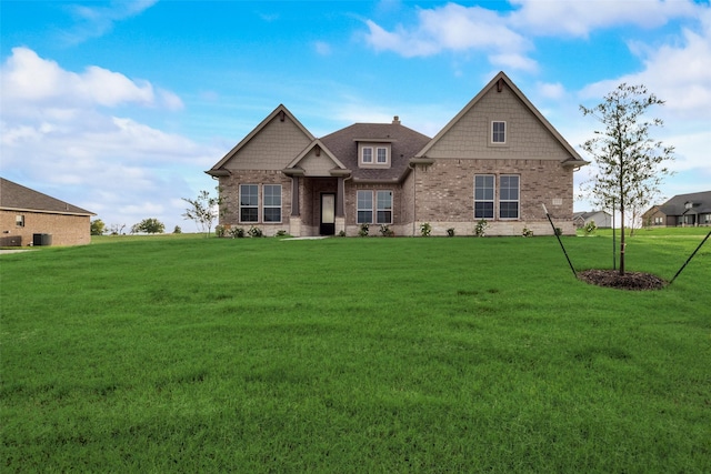 craftsman-style house with a front yard and central AC