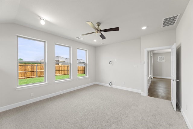 spare room featuring carpet floors, ceiling fan, and vaulted ceiling