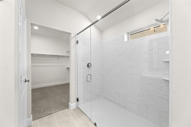 bathroom featuring a shower with door and tile patterned flooring