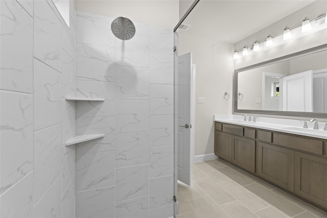 bathroom featuring vanity, tiled shower, and tile patterned floors