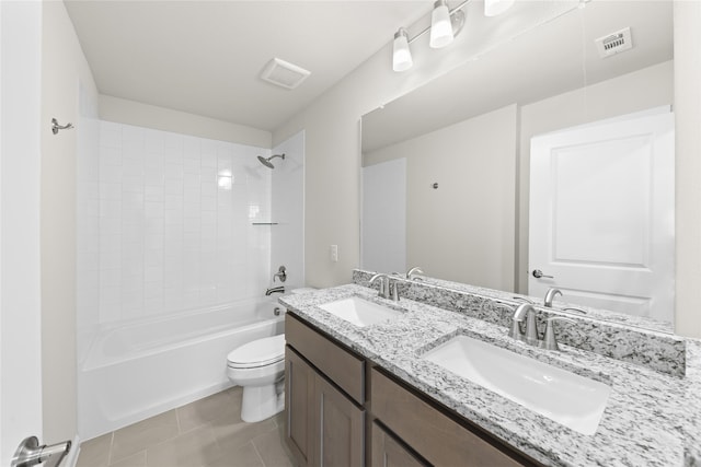 full bathroom with toilet, tiled shower / bath, vanity, and tile patterned flooring