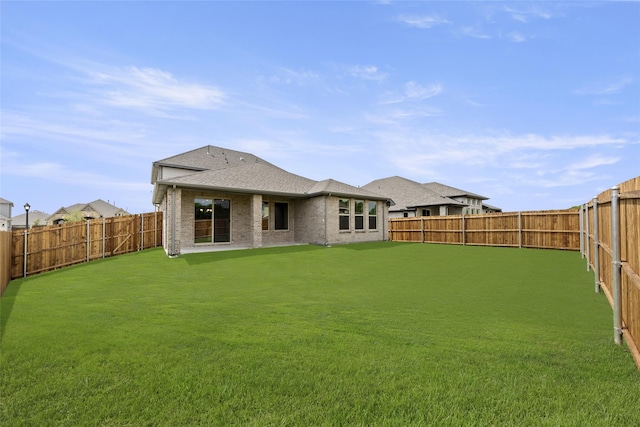 rear view of house with a patio area and a yard