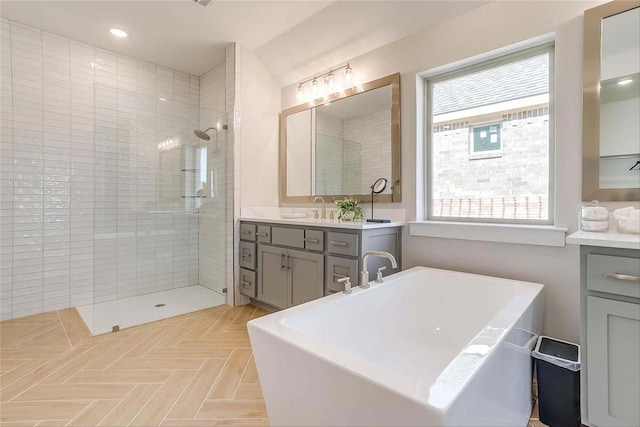 bathroom with vanity, plus walk in shower, parquet flooring, and plenty of natural light