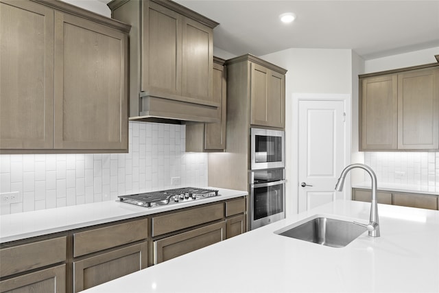 kitchen with decorative backsplash, stainless steel appliances, and sink