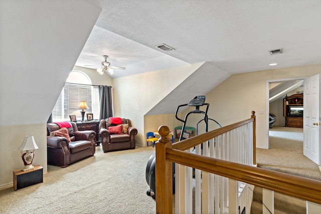 interior space featuring carpet, a textured ceiling, and vaulted ceiling