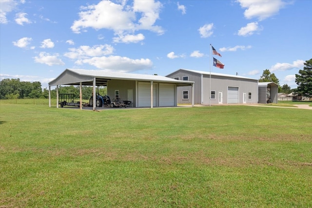 back of property with a garage, a yard, and an outdoor structure