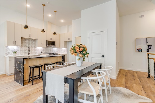 dining space with light hardwood / wood-style flooring