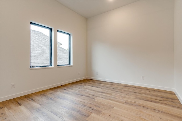 spare room with light hardwood / wood-style flooring