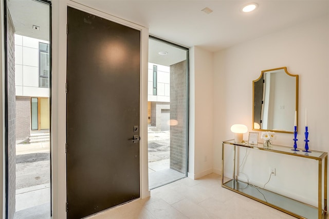 doorway to outside featuring light tile patterned flooring