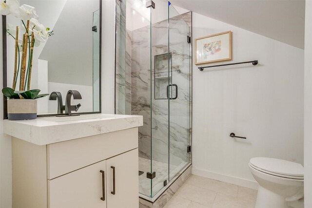 bathroom featuring vanity, toilet, an enclosed shower, and tile patterned flooring