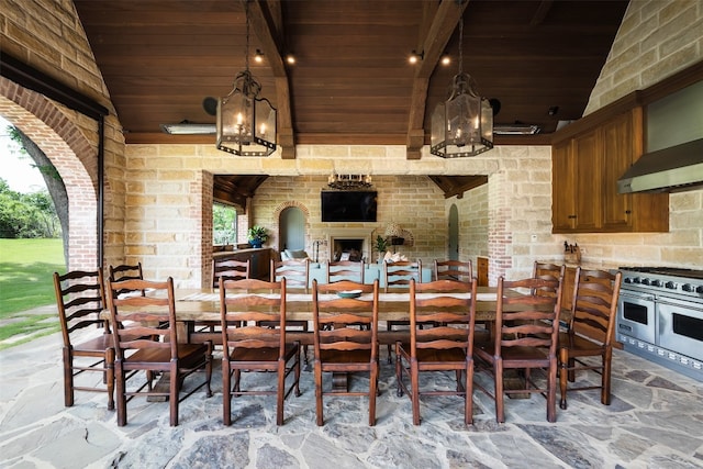 tiled dining area featuring a chandelier, vaulted ceiling, brick wall, and wood ceiling