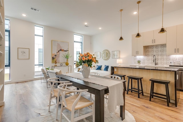 dining space with plenty of natural light and light hardwood / wood-style flooring