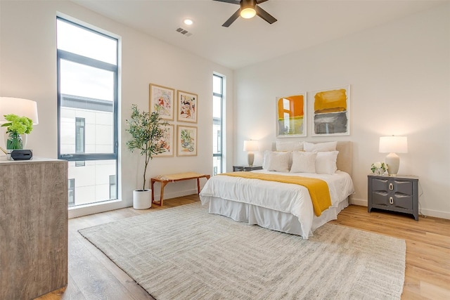 bedroom with light wood-type flooring and ceiling fan