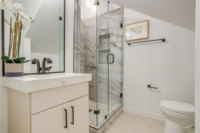 bathroom featuring vanity, toilet, a shower with shower door, and tile patterned floors