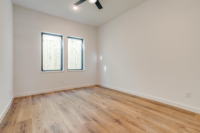 empty room with ceiling fan and light hardwood / wood-style floors