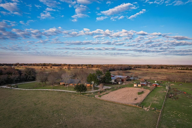 aerial view at dusk featuring a rural view