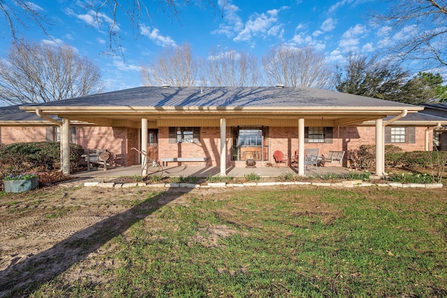 ranch-style house featuring a patio area, a front lawn, and brick siding