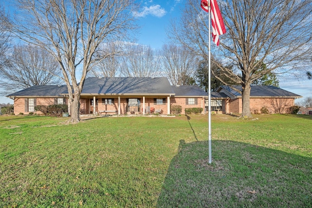 ranch-style home with brick siding and a front yard