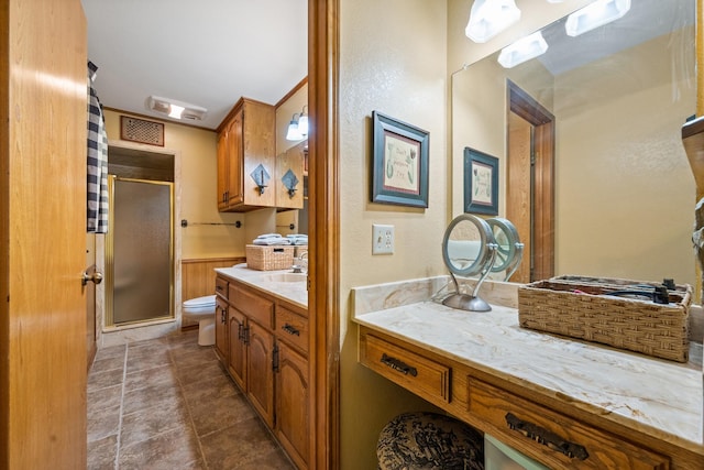 full bathroom with toilet, a shower stall, and vanity