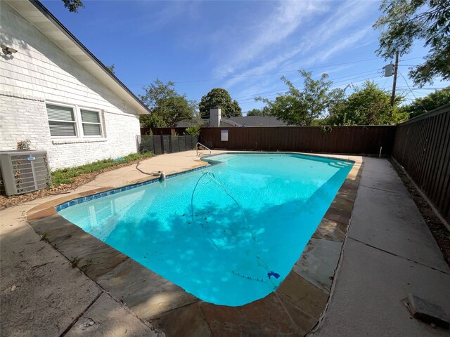 view of swimming pool featuring a patio area and cooling unit