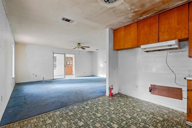 spare room with ceiling fan and carpet