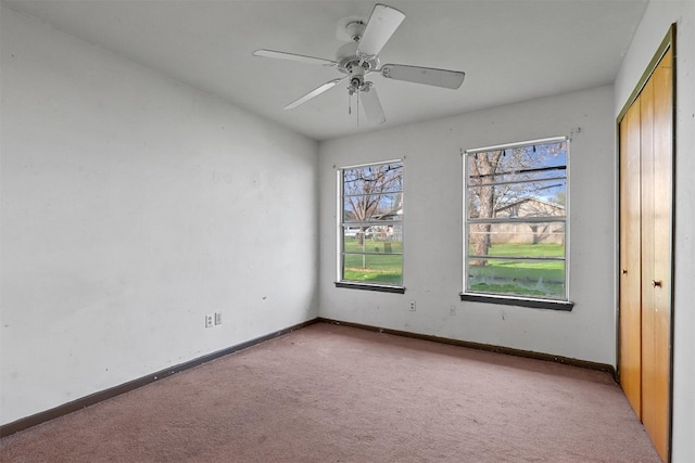 unfurnished bedroom featuring ceiling fan and light carpet