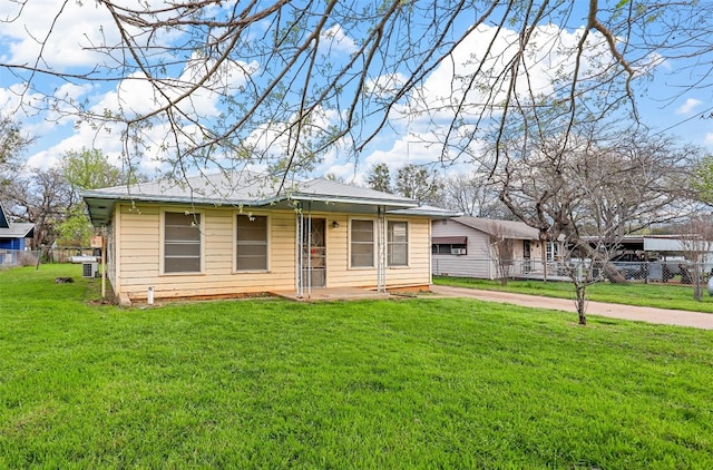 ranch-style home with a front lawn and central AC unit