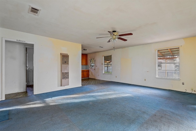 carpeted empty room featuring ceiling fan