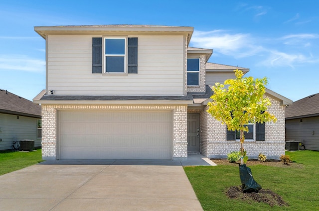 view of property with a garage, central AC, and a front lawn