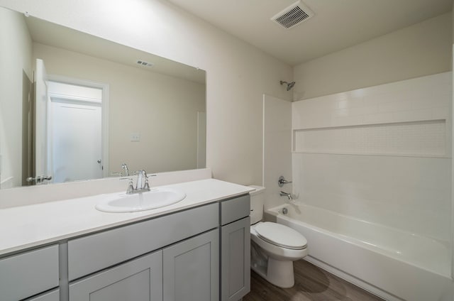 full bathroom with shower / bathtub combination, vanity, toilet, and hardwood / wood-style floors