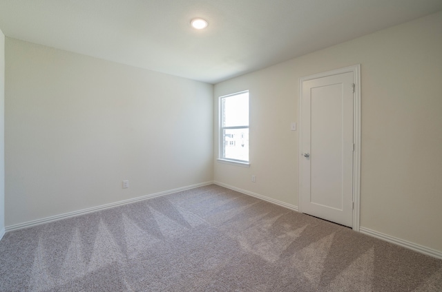 spare room featuring carpet