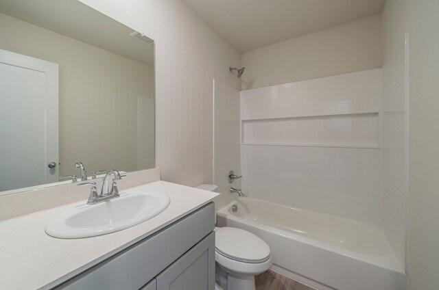 full bathroom featuring vanity, shower / bath combination, toilet, and hardwood / wood-style floors