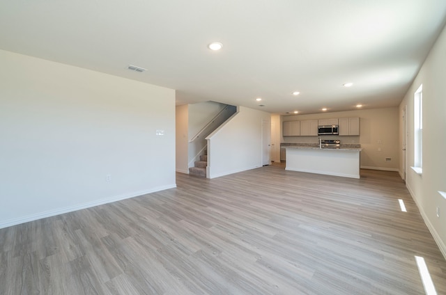 unfurnished living room with light hardwood / wood-style flooring