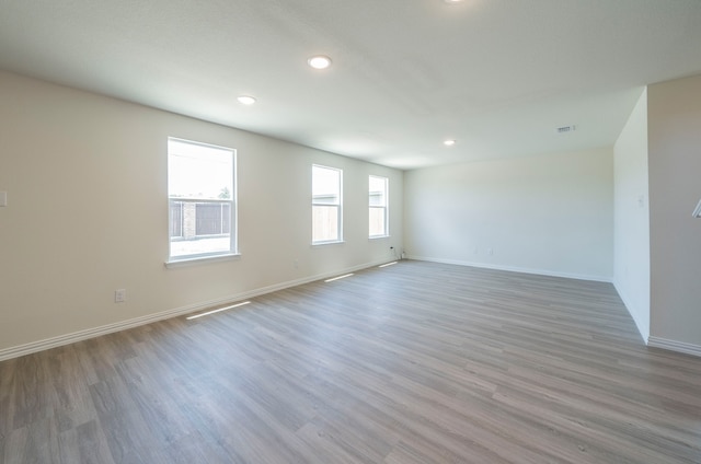 spare room with wood-type flooring